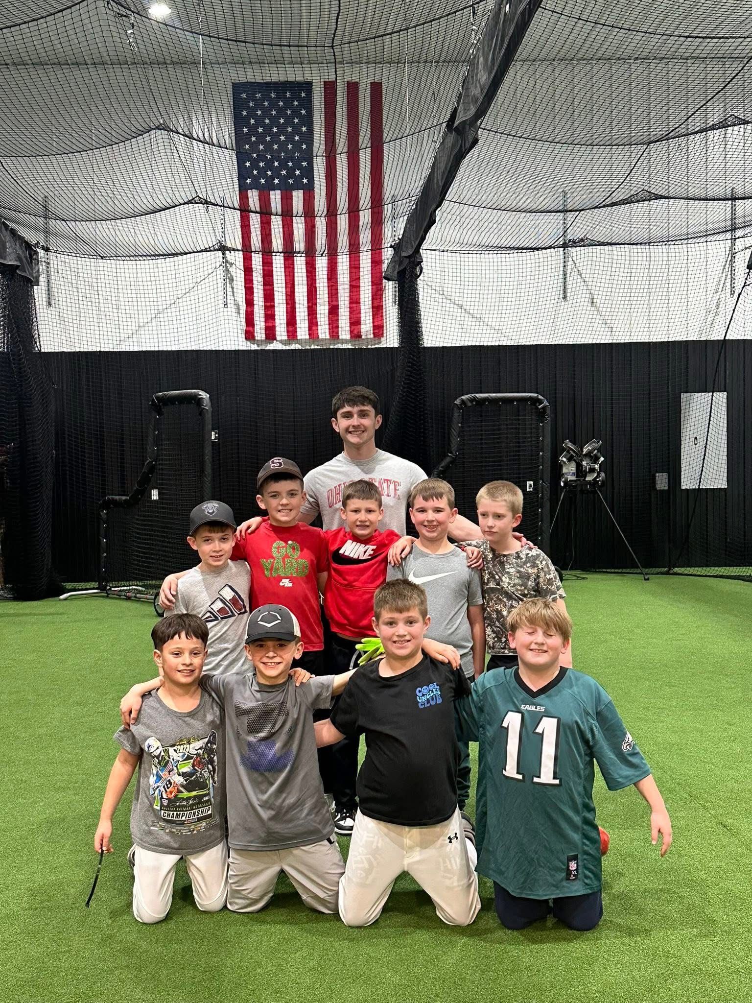 Softball player training with the Hack Attack Softball Pitching Machine