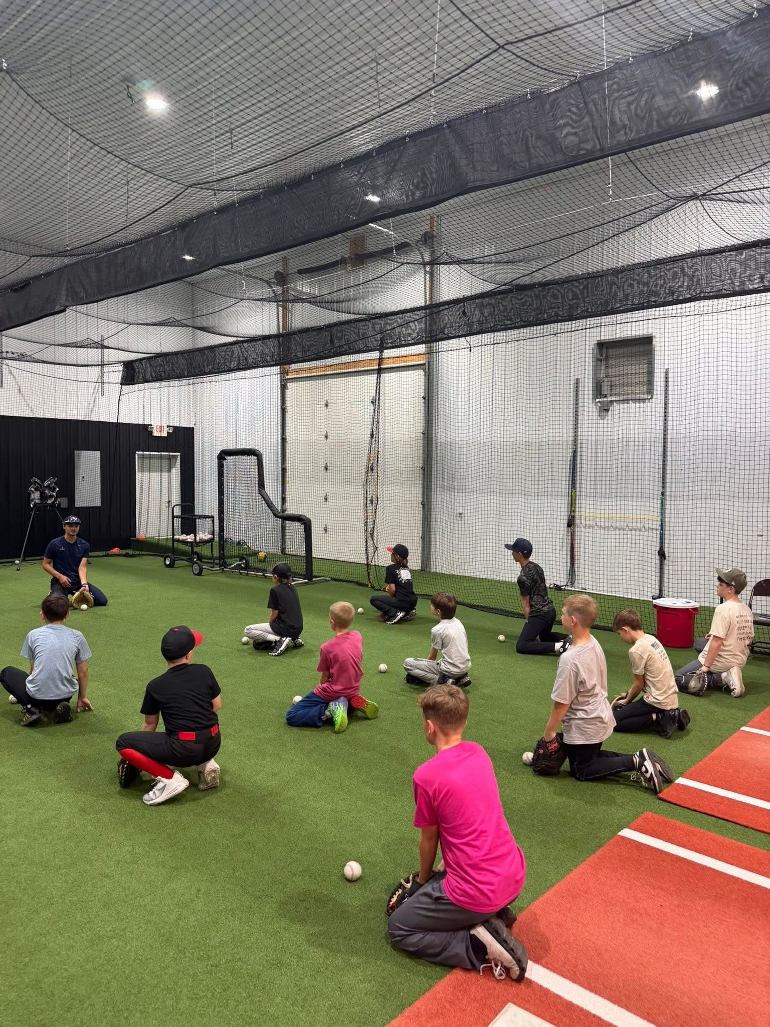 Baseball hitting practice inside The Hitting House indoor batting cages