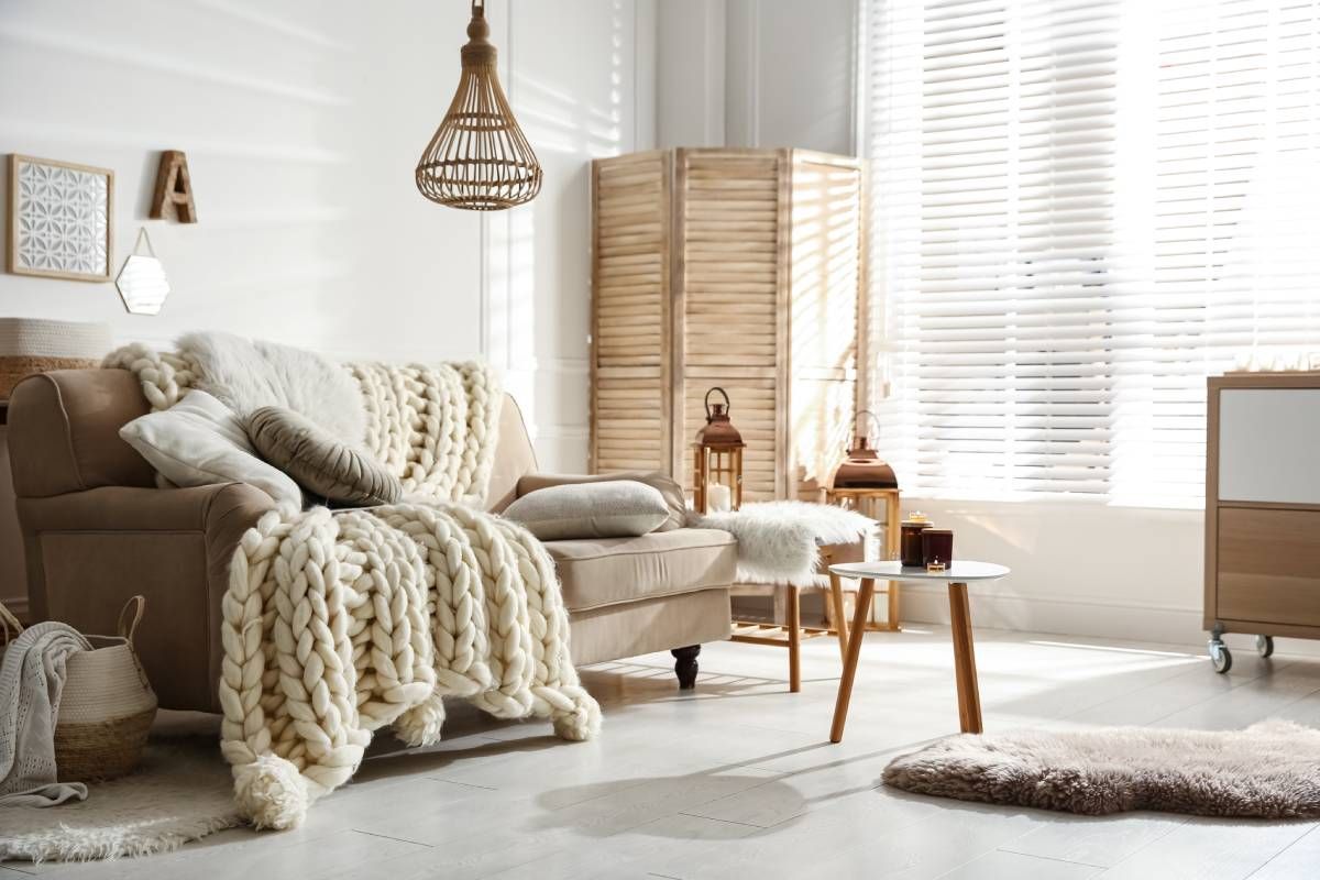 bright white living room with rays of sunlight shining through white blinds near San Diego, California
