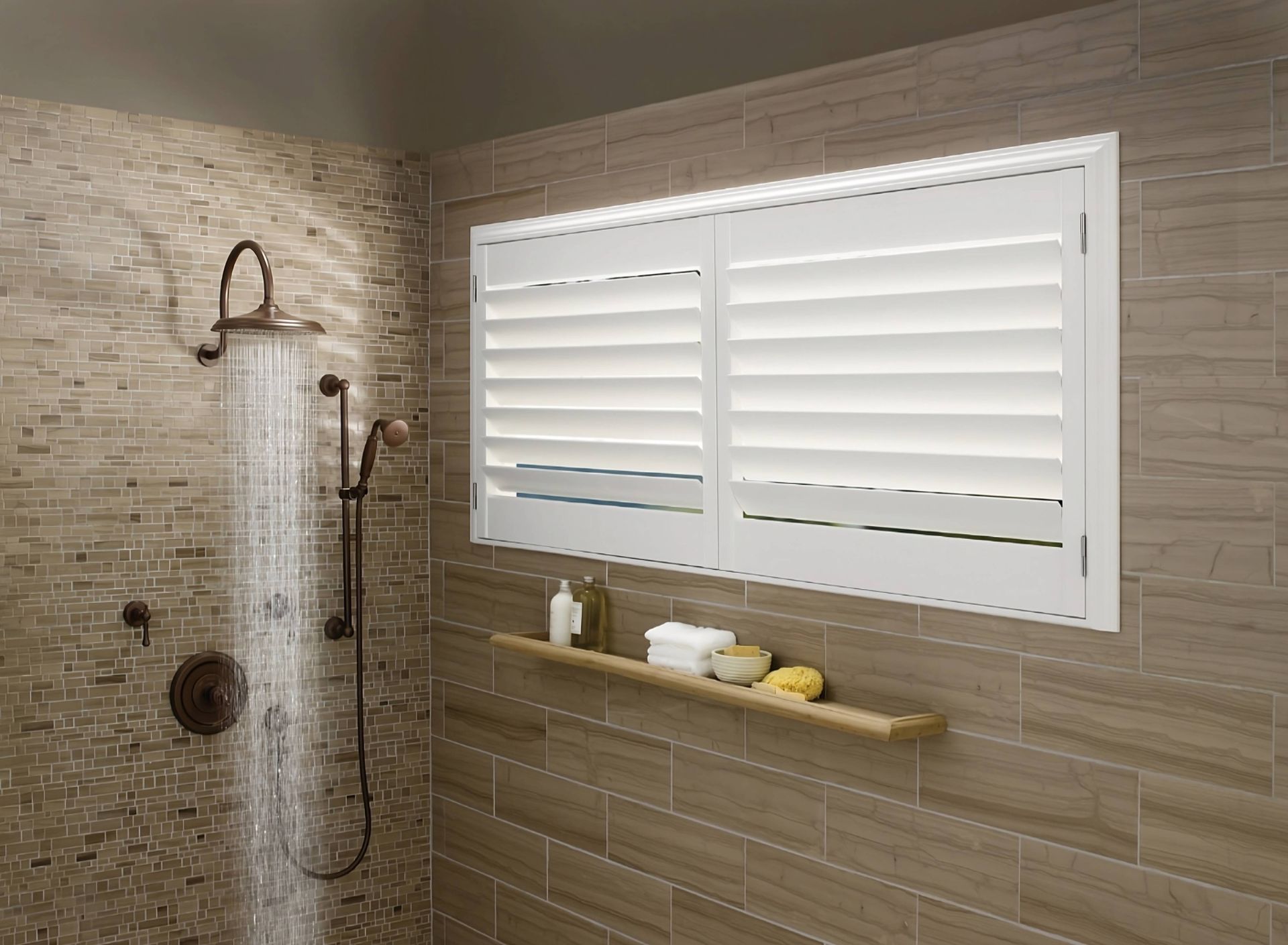 White Hunter Douglas bathroom shutters, in a closed position, inside a spacious and contemporary walk-in shower at Harmony Blinds & Shutters near San Diego, CA