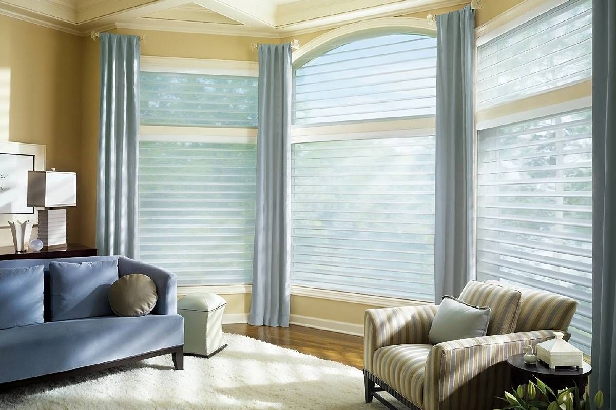Warm living with large arched windows with luxurious window coverings near San Diego, California