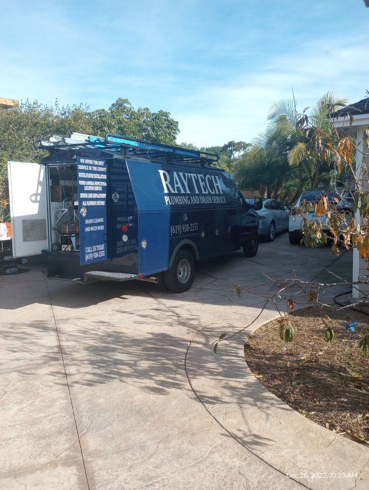 Blue Ray Tech van parked on a driveway, door open, hoses running, sunny day.
