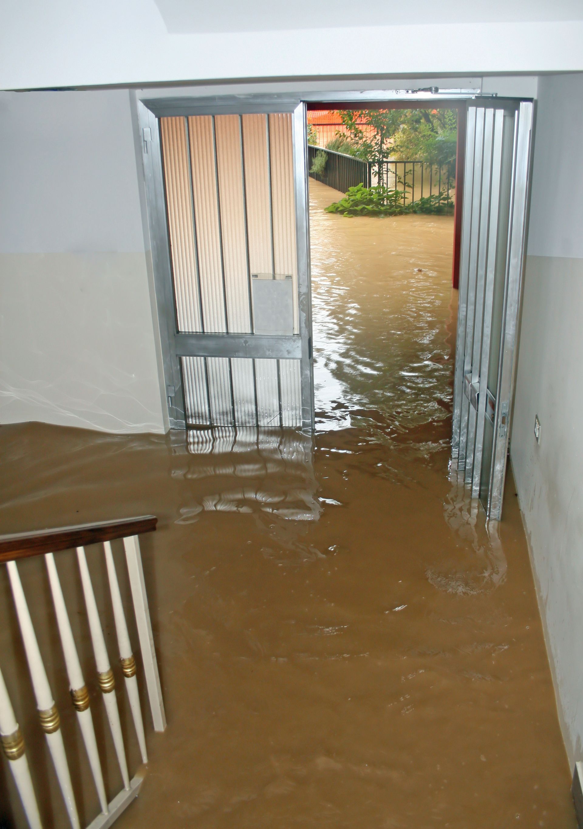 Severe flooding damages a home entryway, requiring flood water damage restoration in Tupelo, MS, by 