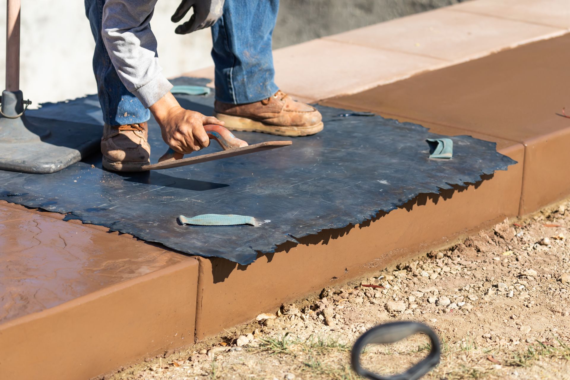A concrete driveway is being built in front of a house.