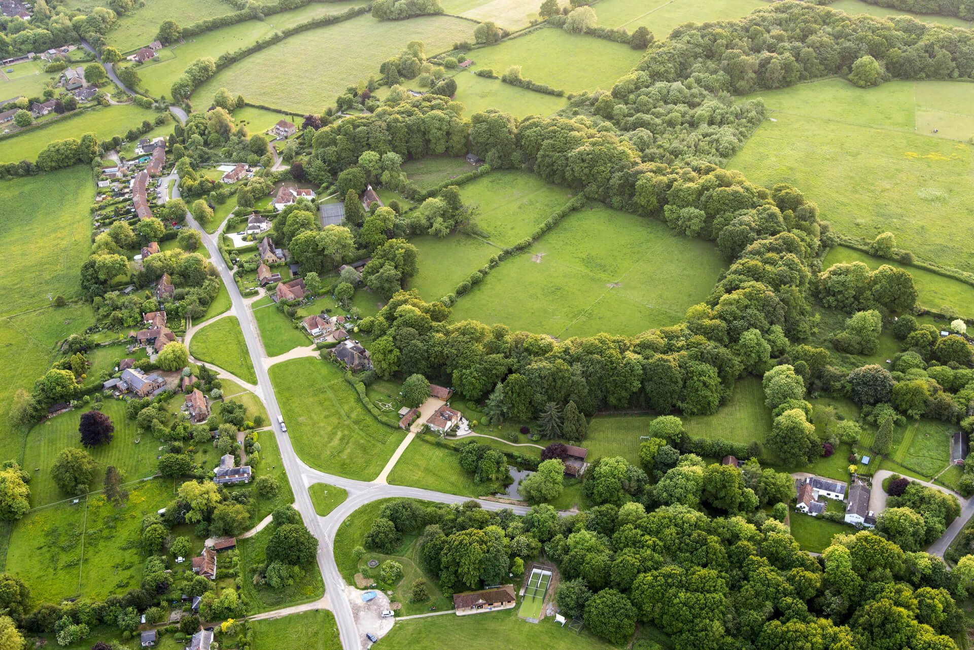Aerial view of fields and building plots in the Kent and Sussex countryside