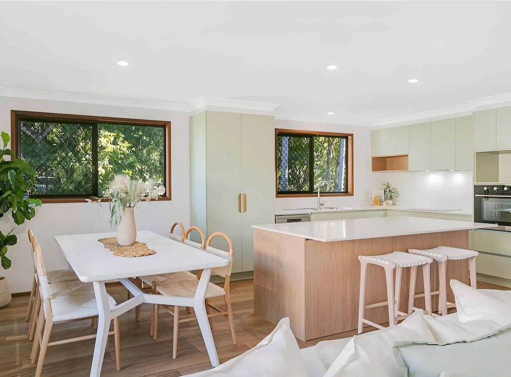 A Living Room With A Dining Table And Chairs And A Kitchen — D & L Custom Cabinets In South Murwillumbah, NSW