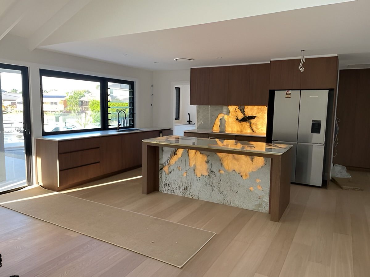 A Kitchen With A Marble Counter Top And A Refrigerator — D & L Custom Cabinets In South Murwillumbah, NSW