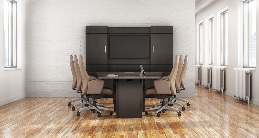 Conference room with a rectangular table, chairs, and a screen on the wall.