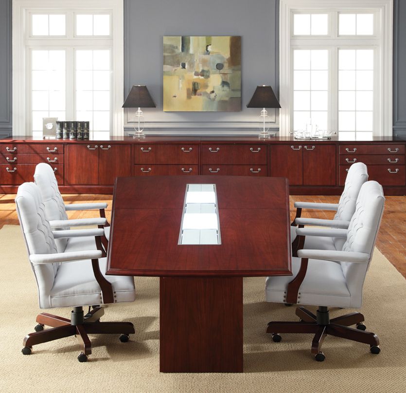 Conference room with mahogany table, white chairs, and dark cabinets. Painting and lamps on the wall.