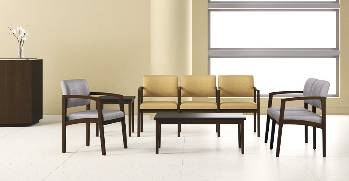 Waiting room furniture: loveseat and chairs with a coffee table, in a well-lit, neutral-toned space.