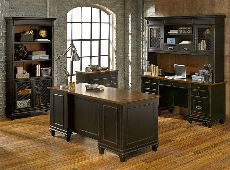 Dark wood office furniture set with desk, hutch, bookcase, and brick wall backdrop.