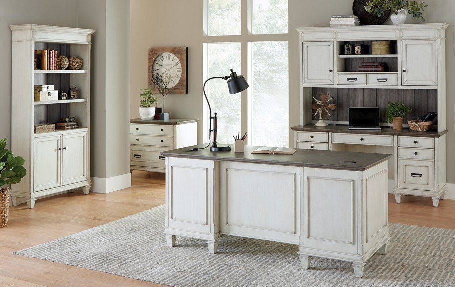 White office furniture set with a desk, hutch, bookcase, and chest of drawers in a room with a window.