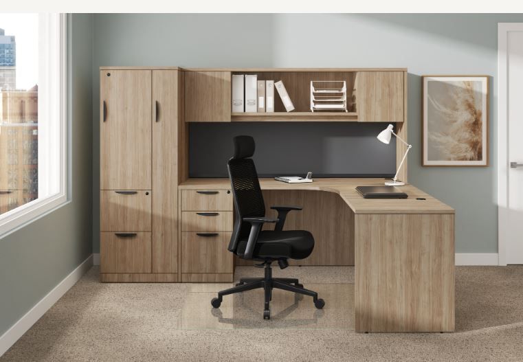 Office desk setup with L-shaped desk, cabinets, chair, and a window.