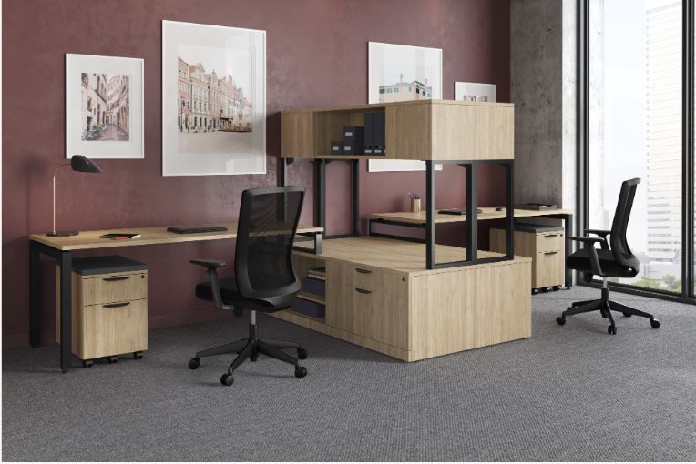 Office space with desks, chairs, storage, and artwork. A window with a city view.