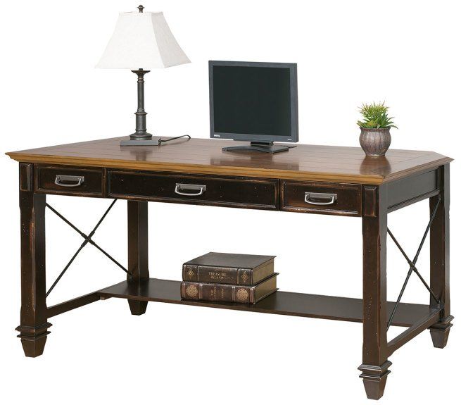 Dark wood desk with a lamp, computer, decorative plant, and books.