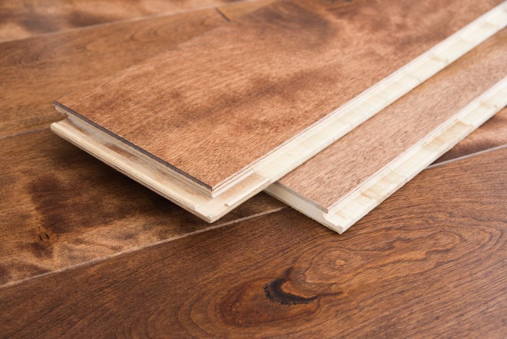 Three Pieces of Wood Are Stacked on Top of Each Other on a Wooden Floor — Freedom Flooring Pty Ltd in Toronto, NSW