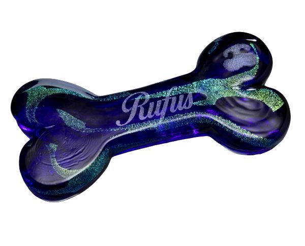 Blue and purple dog bone-shaped item with “Rygus” text and glittery finish