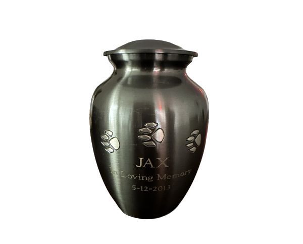 Black engraved urn with paw prints and “JAX” on the front, isolated on a white background