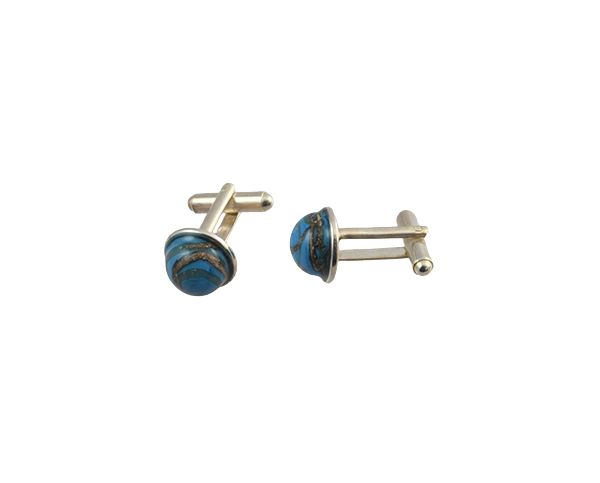 Pair of silver cufflinks with blue striped round faces on a white background