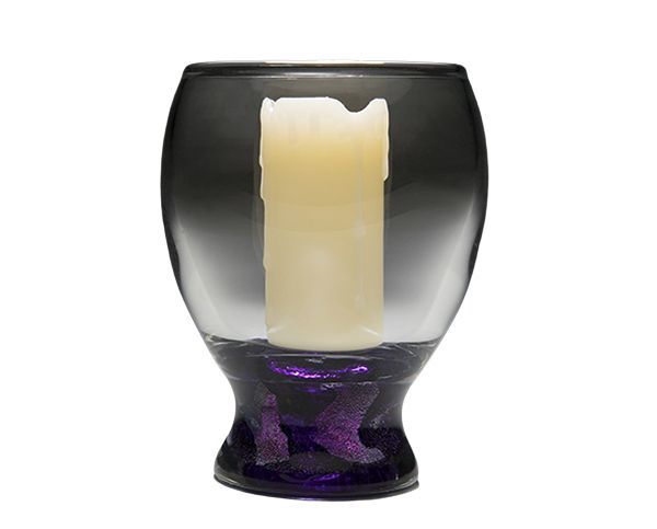 Dark smoked glass candle holder with a cream pillar candle inside