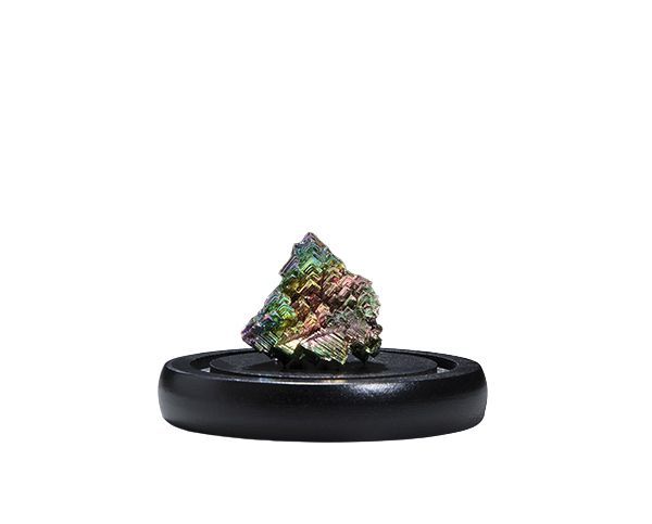 Small iridescent mineral specimen on a black display stand against a white background
