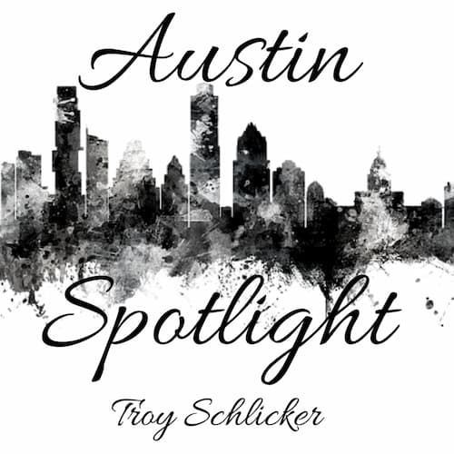 A black and white logo for austin spotlight by troy schlicker.