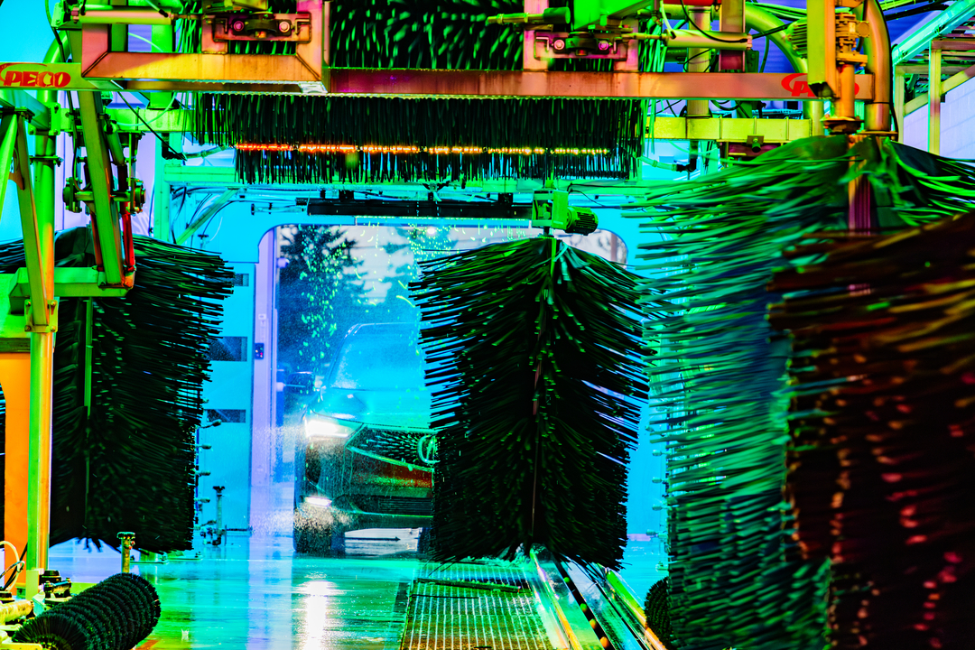 Colorful abstract industrial walkway with metal pipes, railings, and trees in the distance