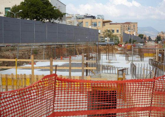 a construction site with a fence in the foreground