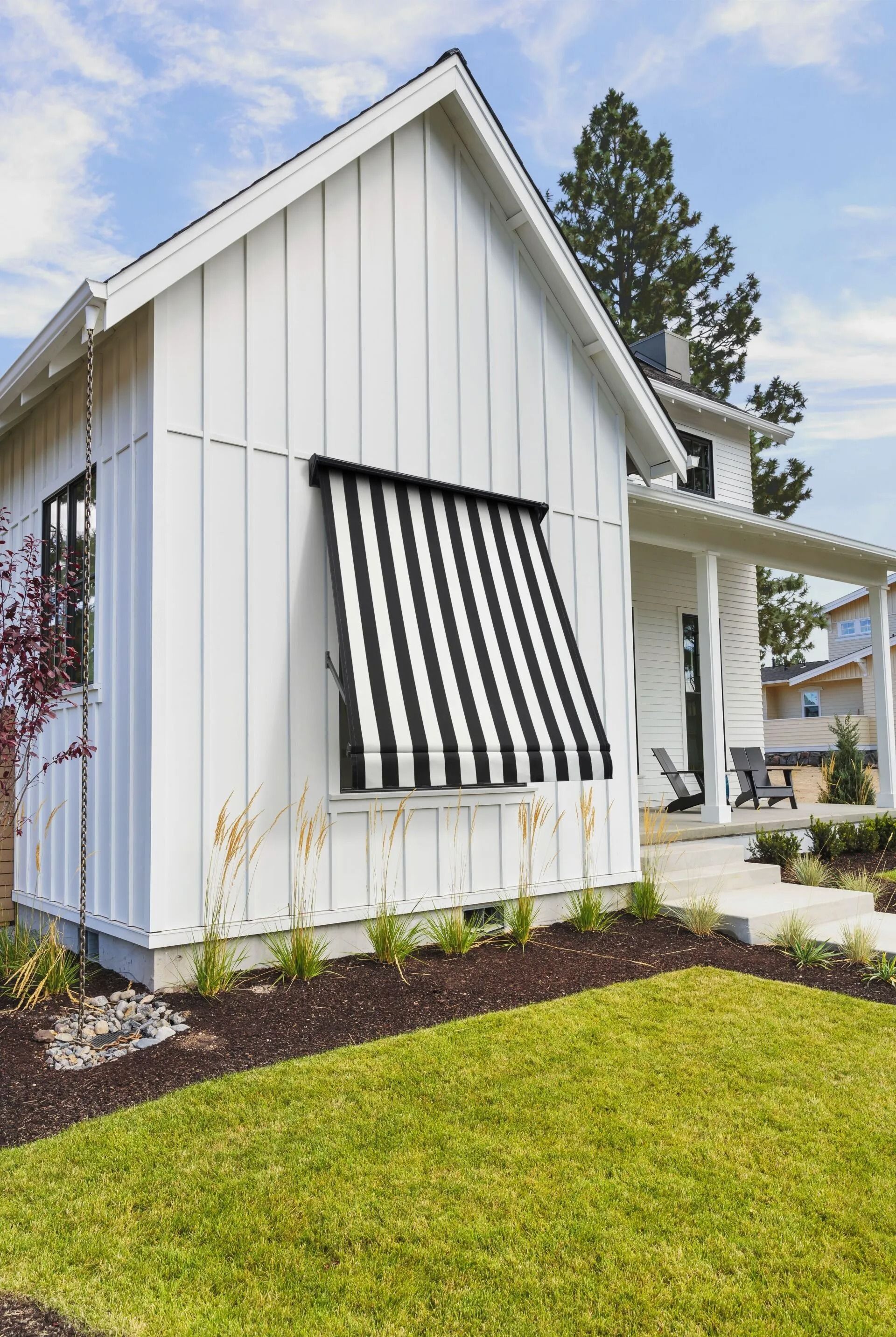 White House With Black and White Striped Awning Over a Window — Red Door Decor In Dubbo, NSW