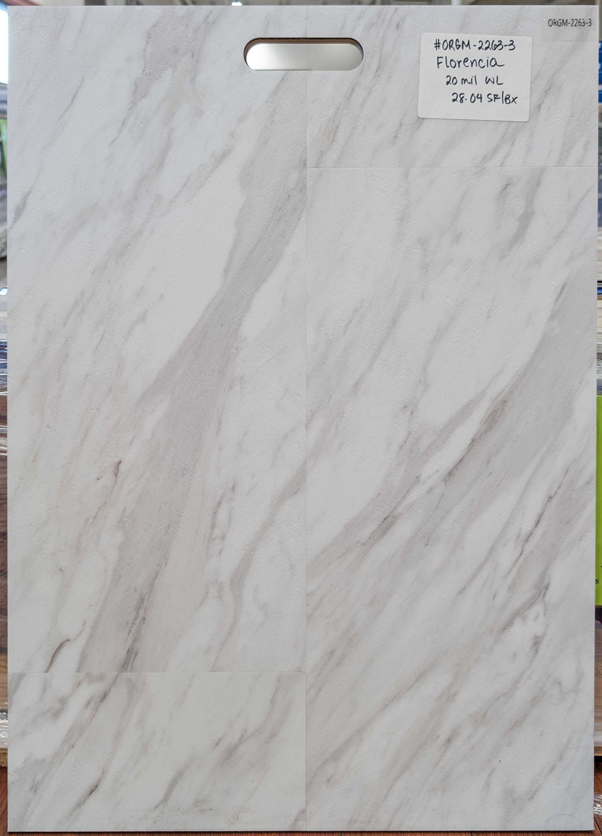 Marble-patterned flooring sample with a handle at the top. Gray and white swirls.