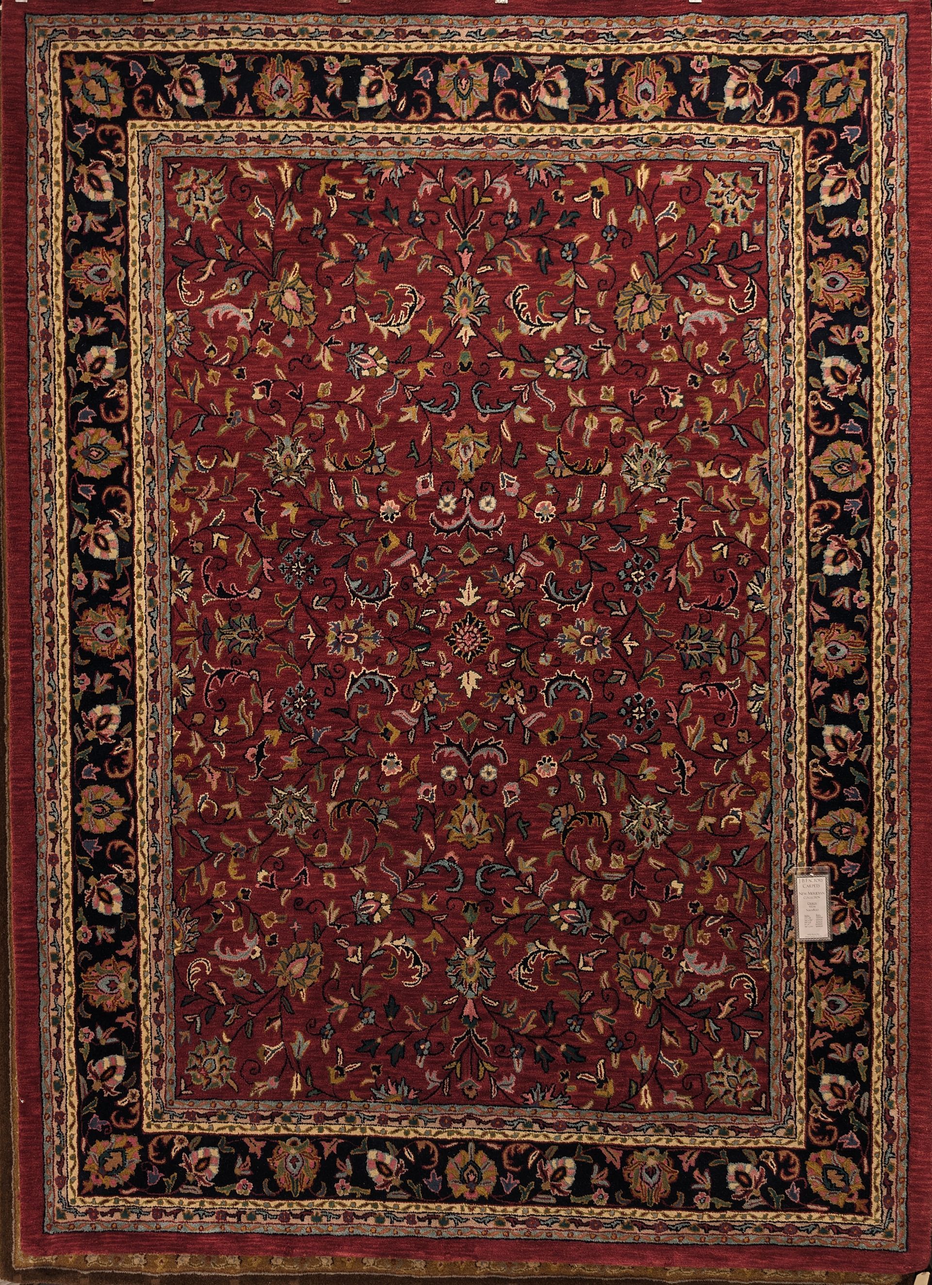 Red patterned area rug with ornate gold border and floral motifs