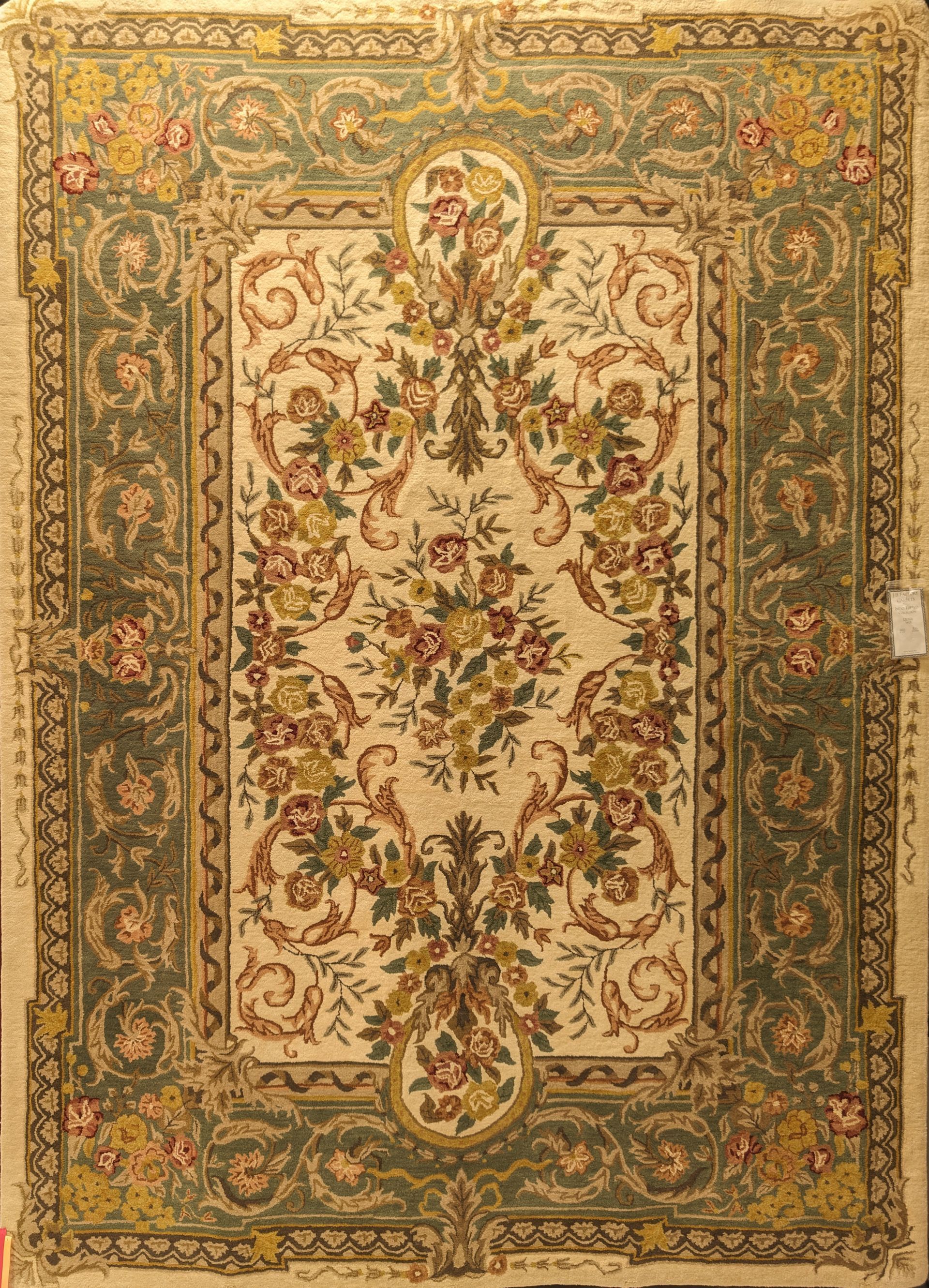 Ornate beige and gold floral rug with a central medallion and border pattern