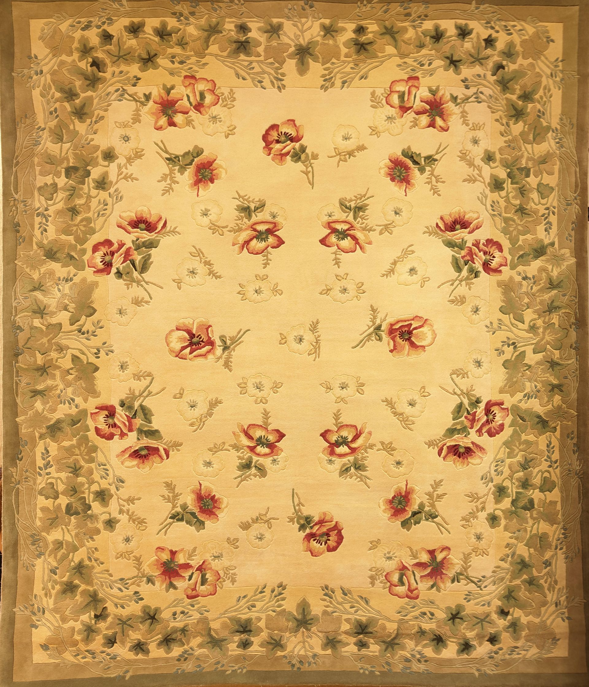 Floral-patterned square rug with a beige background and pink-red flower clusters around the border.