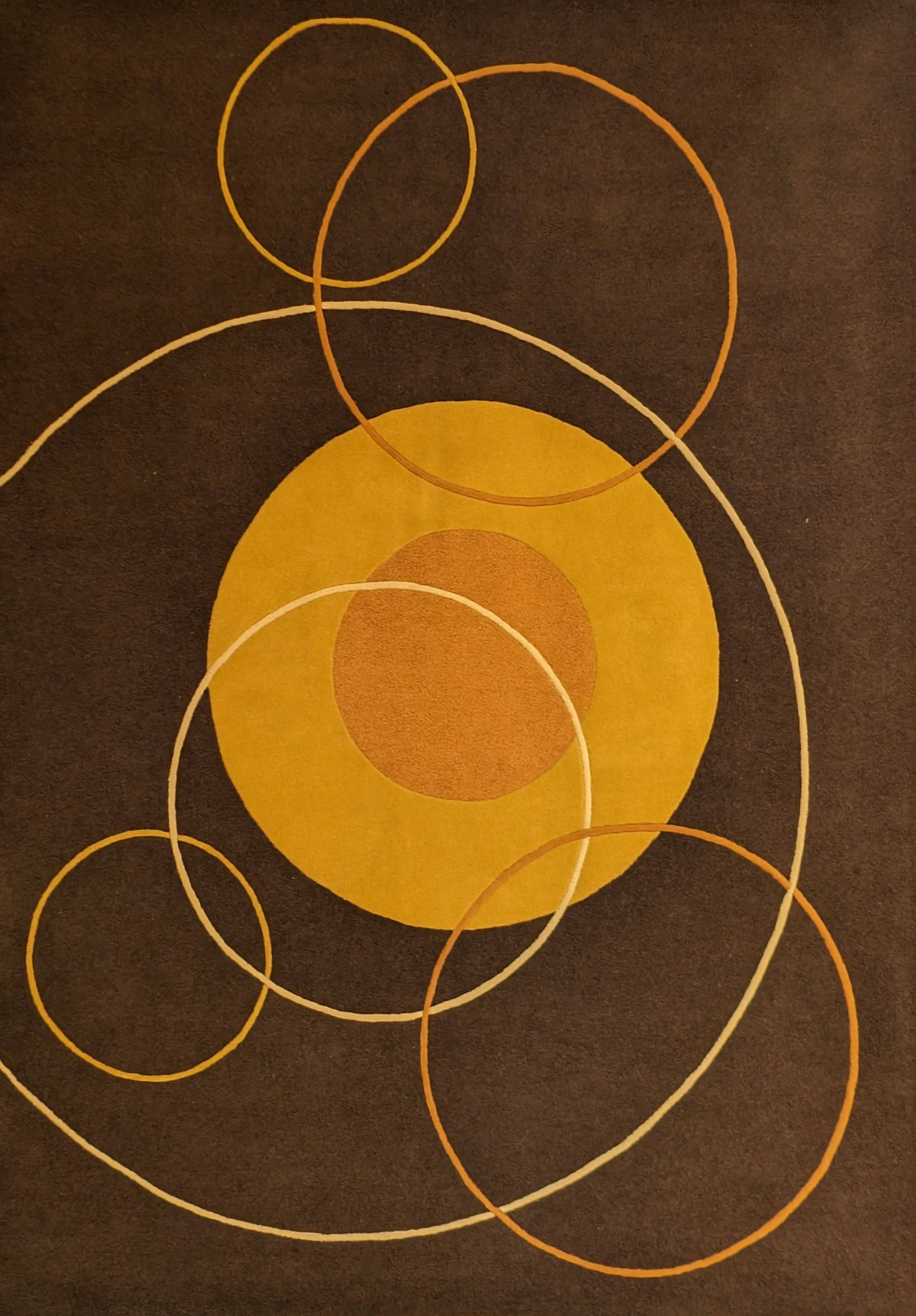 Abstract geometric design with overlapping golden circles on a dark brown background