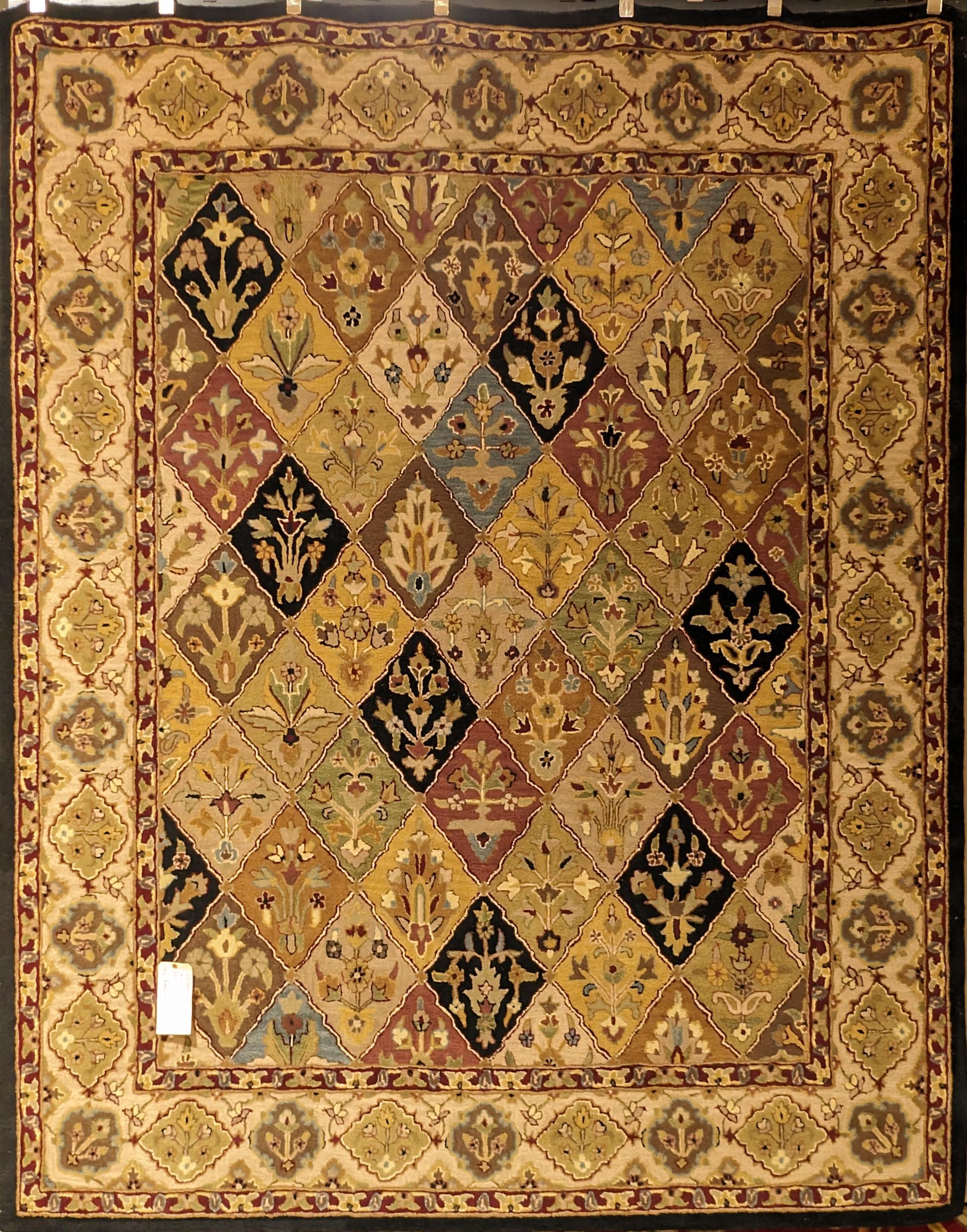 Ornate vintage rug with gold, brown, and black geometric diamond and floral patterns