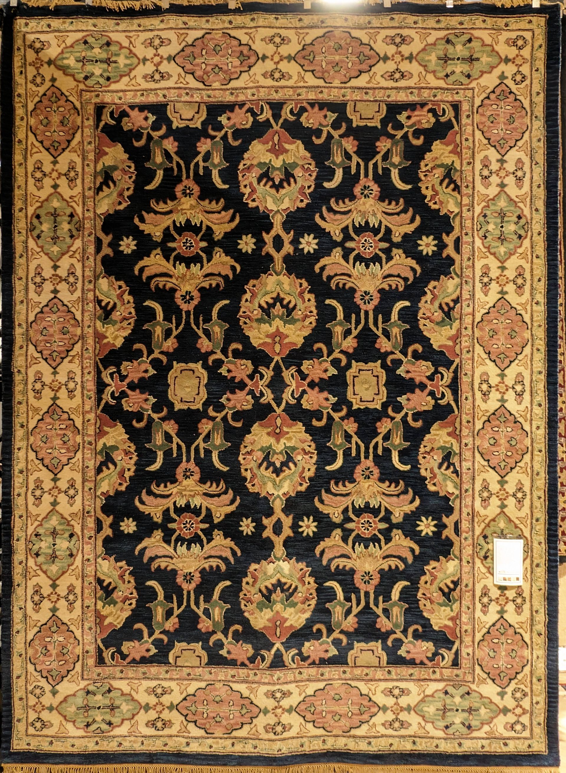 Ornate beige and gold floral rug with a black center panel and patterned border