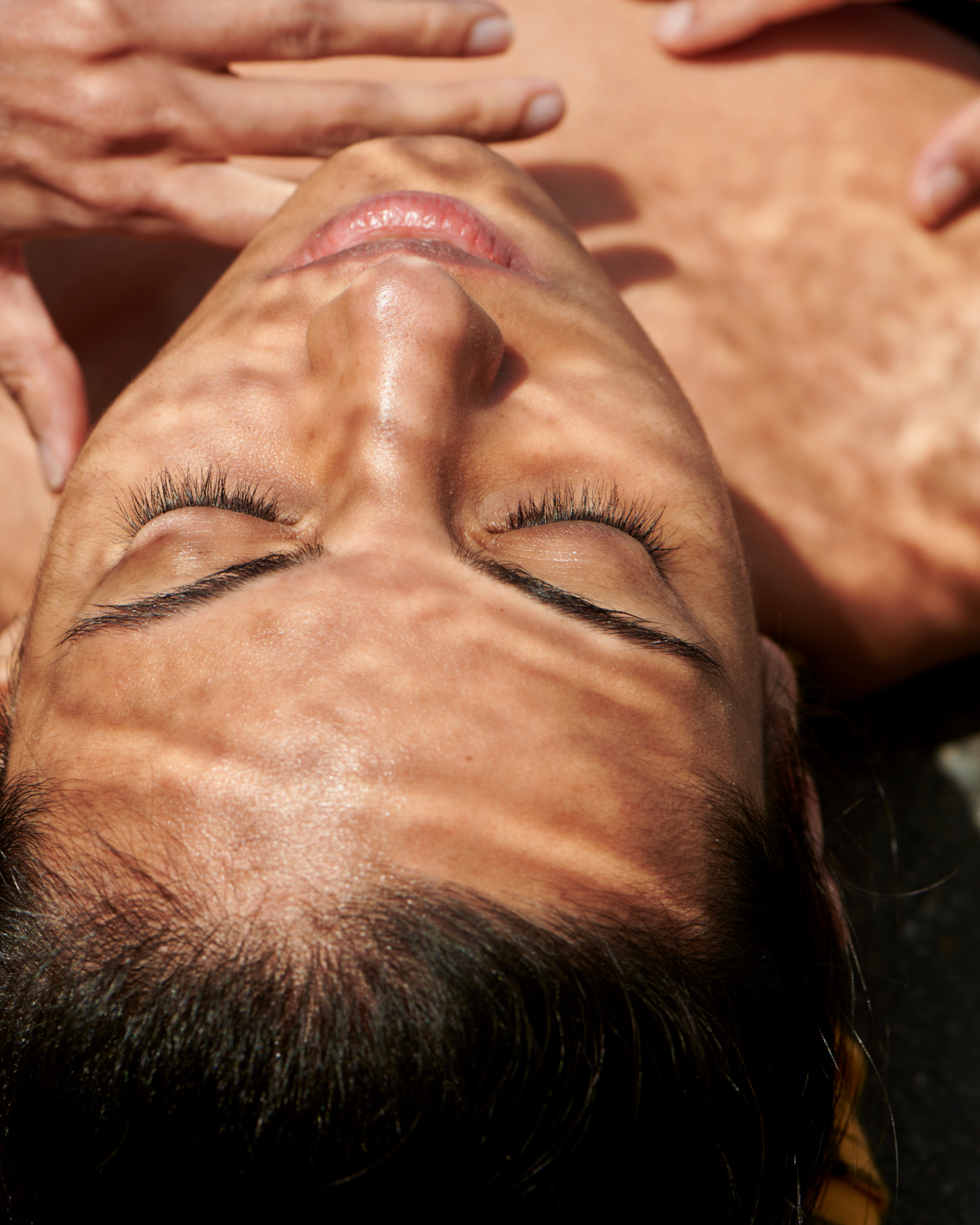 A close up of a woman 's face with her eyes closed