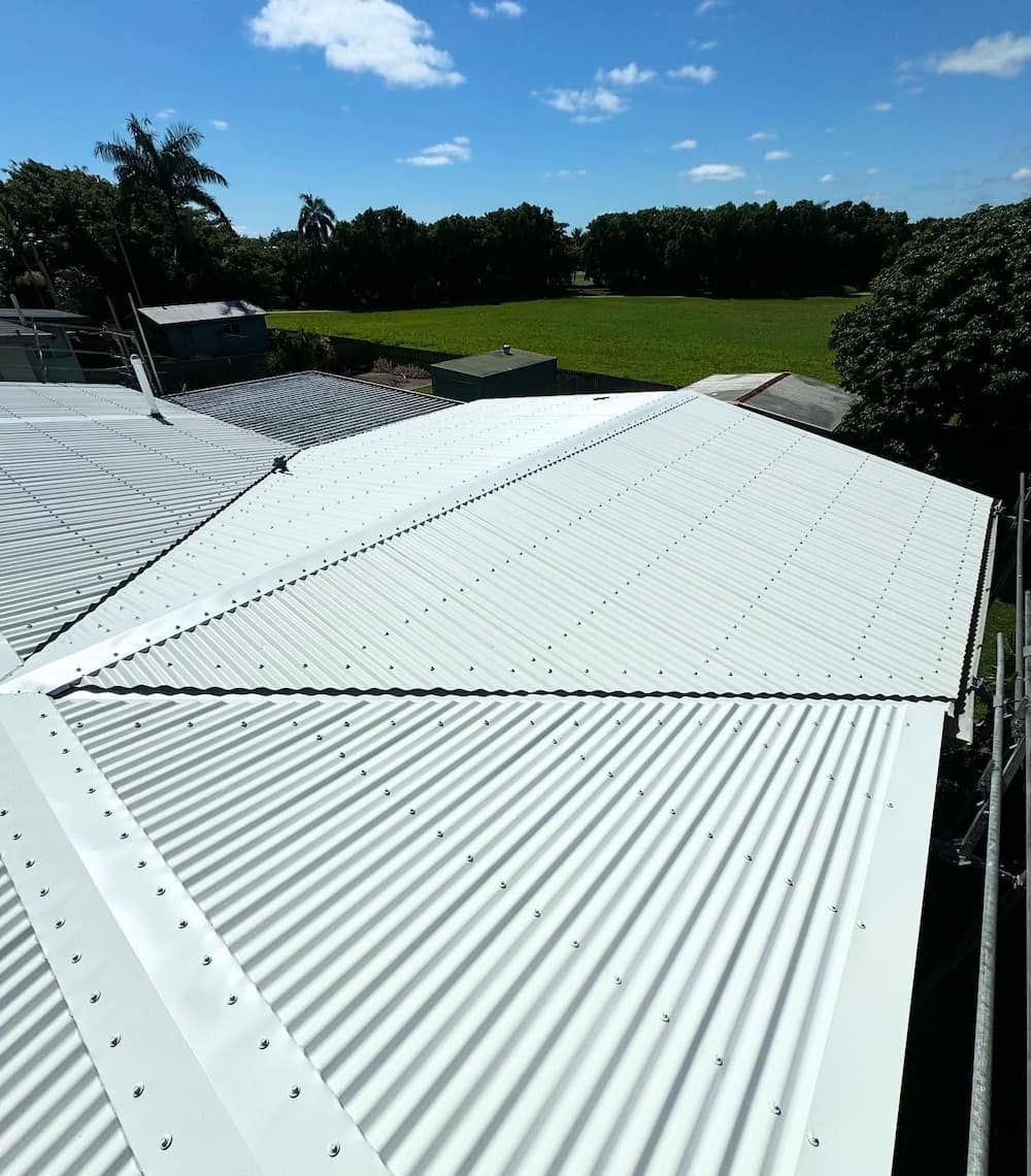 A White Roof With a Blue Sky in the Background — CJM Plumbing & Roofing Mackay in Mackay, QLD