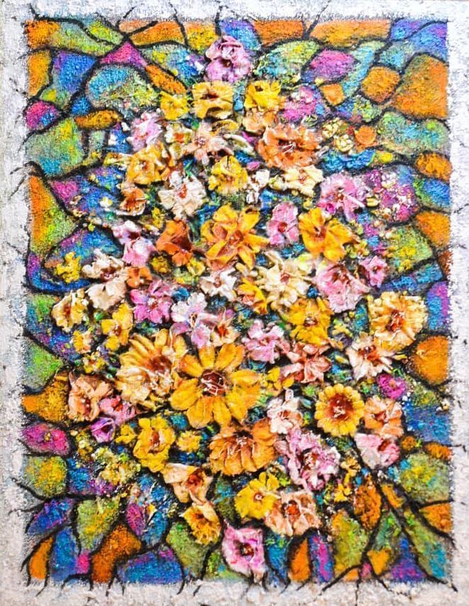 Colorful floral mosaic with yellow, pink, and orange flowers on a cracked stone background