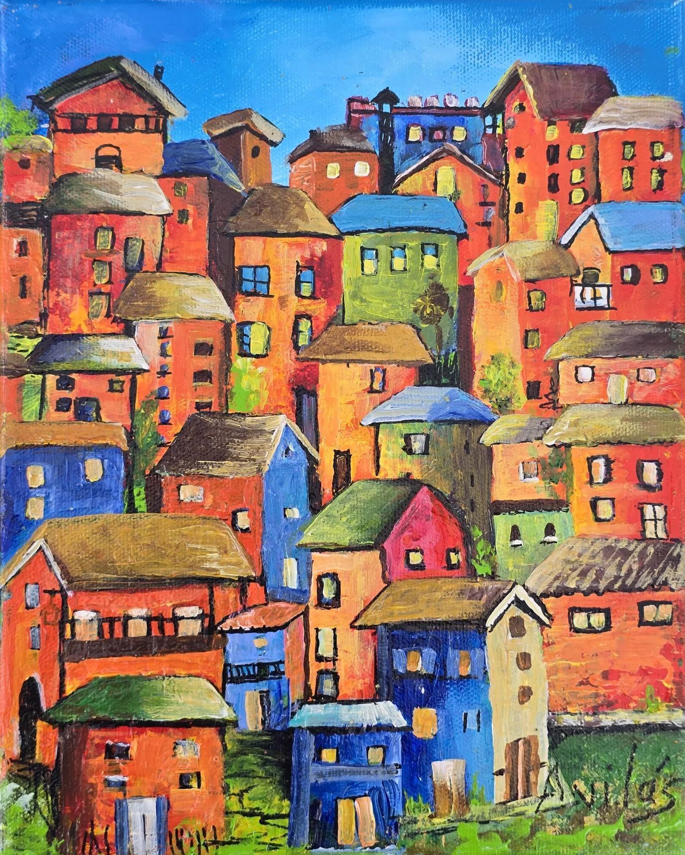 Colorful hillside town with stacked houses in bright red, blue, orange, and green under a blue sky