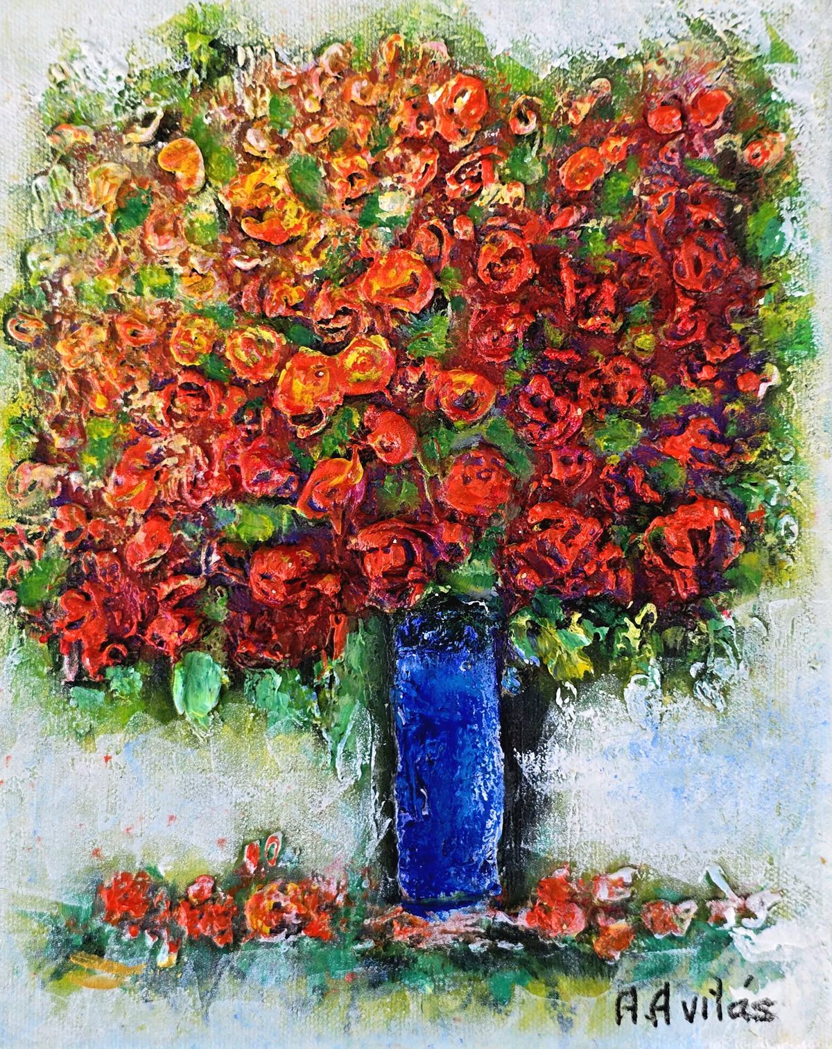 Bright bouquet of red-orange flowers in a tall blue vase on a white background