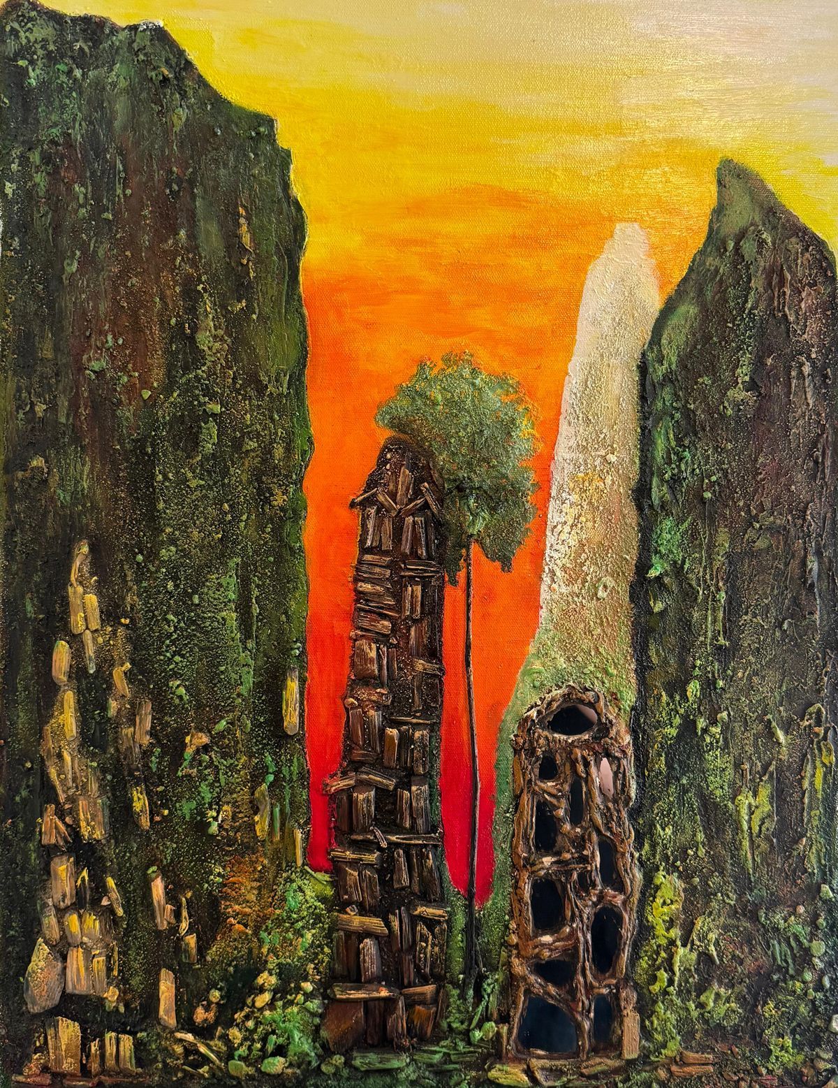 Abstract stone monoliths in a rocky canyon at sunset, with a glowing orange sky and a tree atop the center pillar