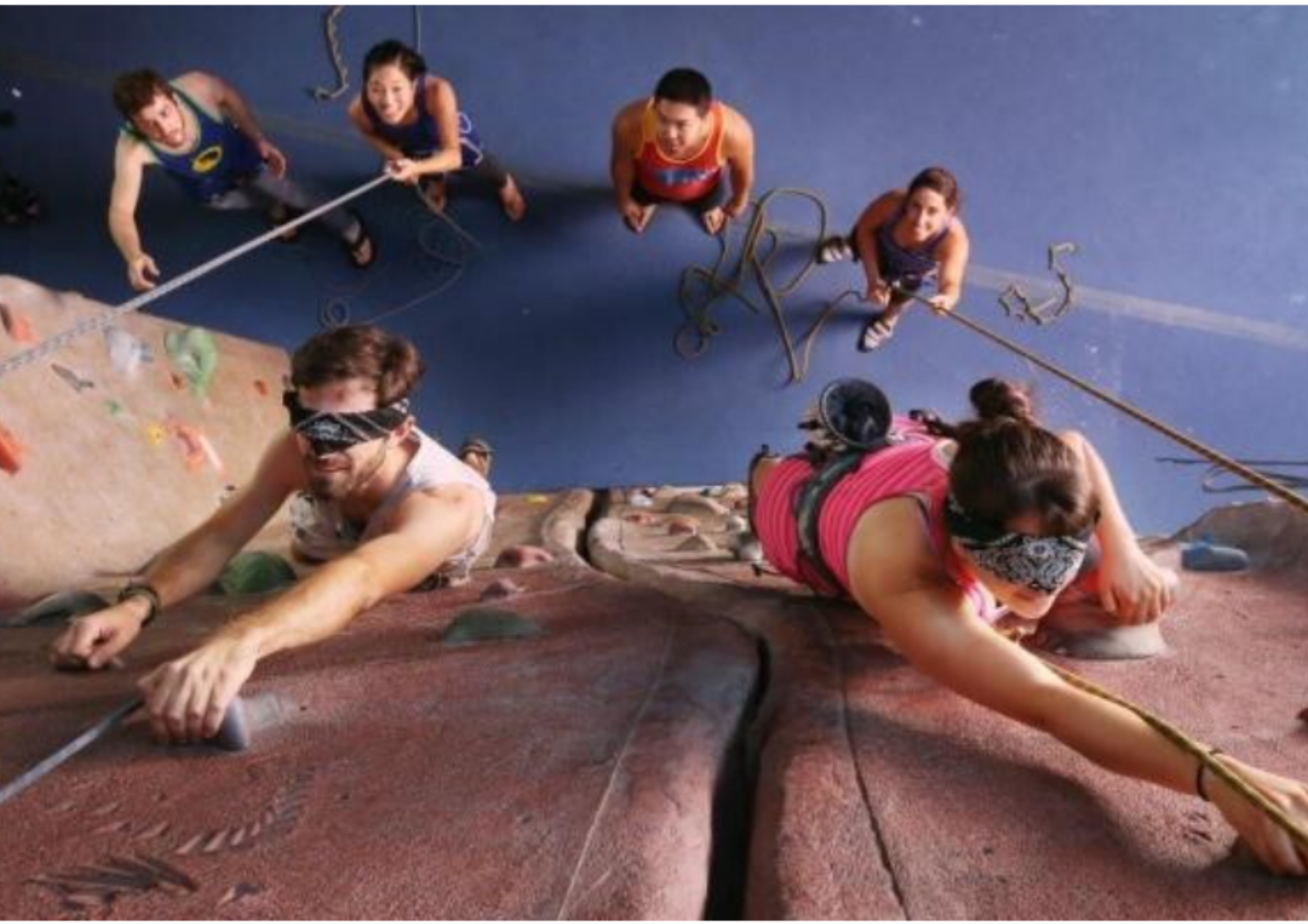 A group of people are climbing a rock wall