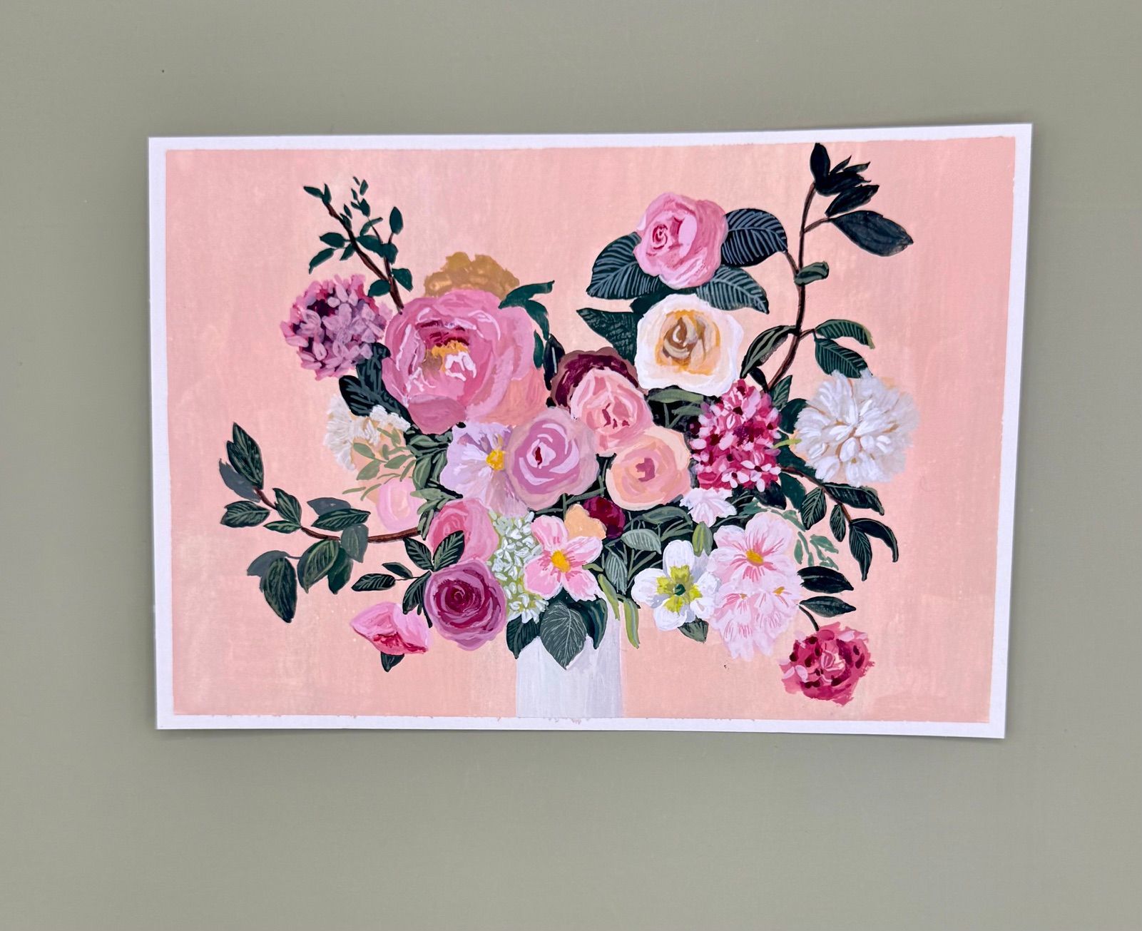 Pink and white floral painting with roses and dark green leaves on a blush background
