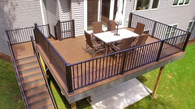 An aerial view of a deck with a table and chairs on it.