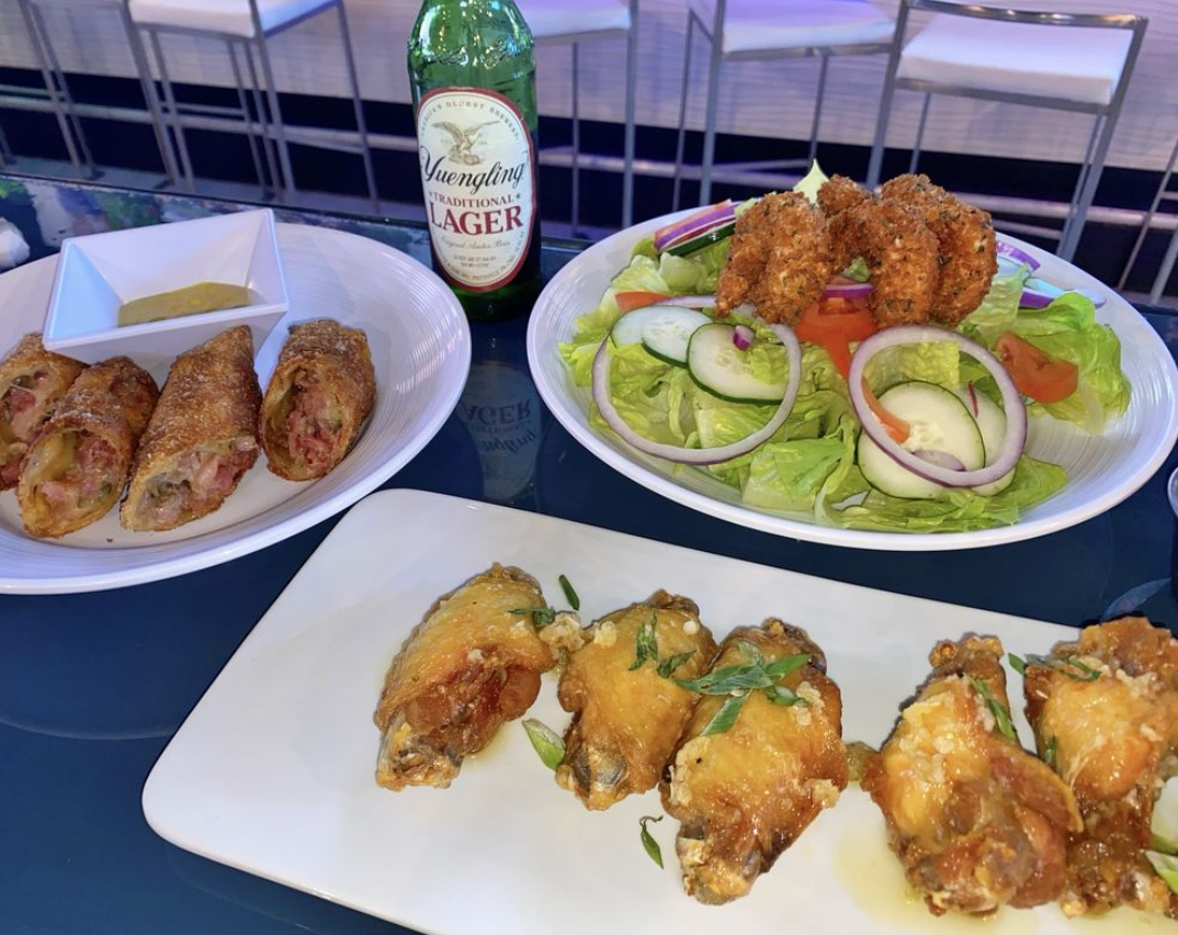image of three plates of food and a beer