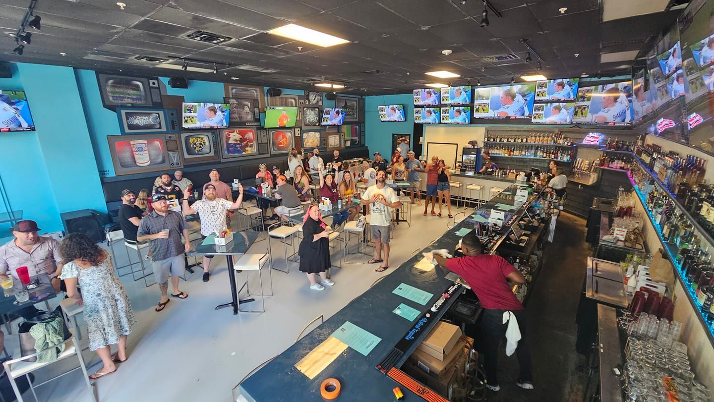 A large group of people are standing in the restaurant.