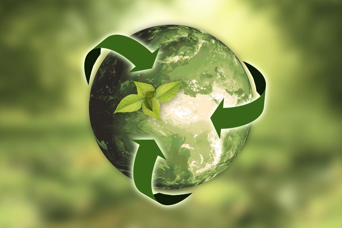 Green planet with recycling arrows