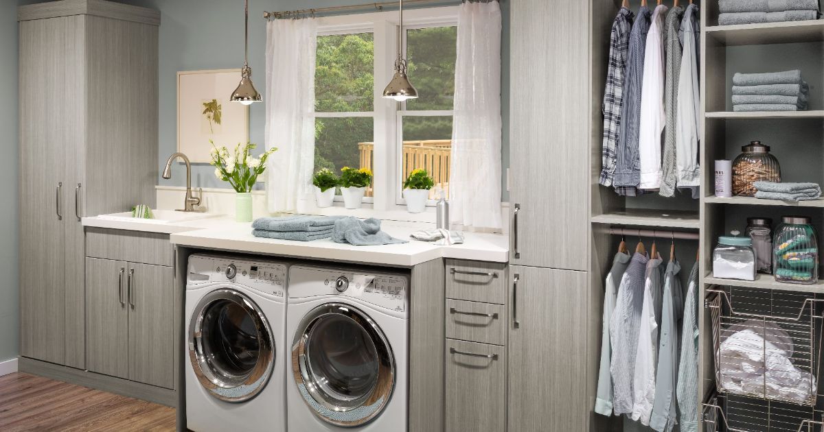 A laundry room with a washer and dryer and a sink.