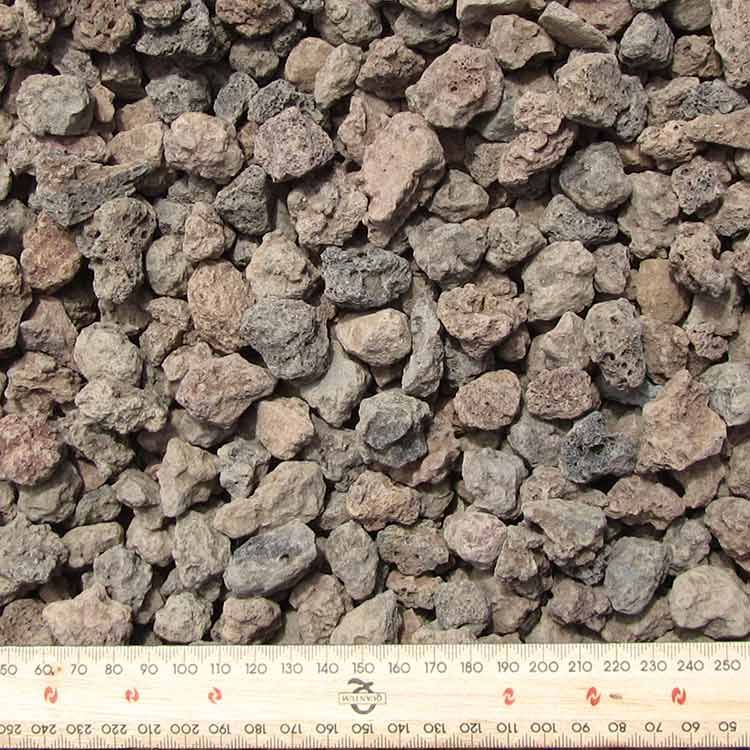 Close-up of Small, Rough, Gray-brown Lava Rocks With a Ruler at the Bottom — Kuranda Landscape Supplies in Kuranda, QLD